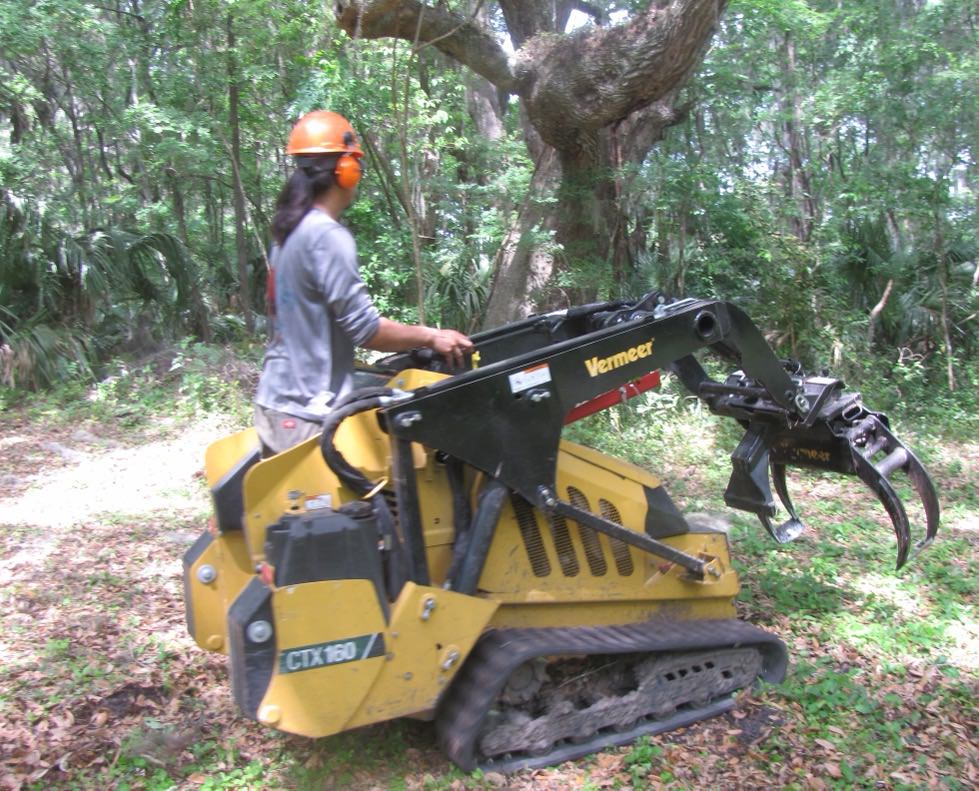 Mini skid steer at a residential property for material handling and site cleanup